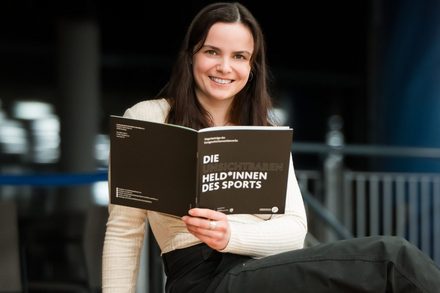 Gewinnerin Felicia Aparicio Lukaßowitz hält die Broschüre in der Hand